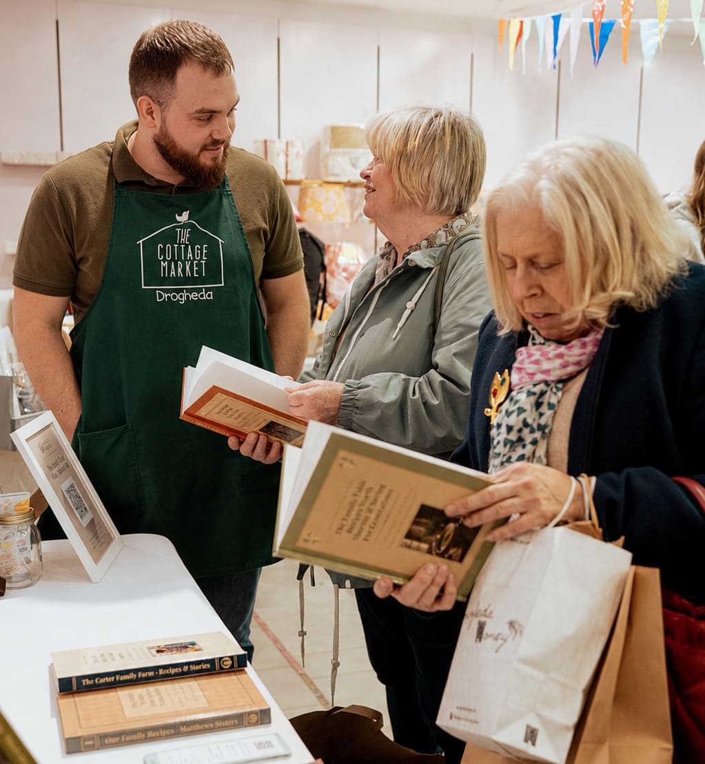 Family members looking through Tasteful Memories cookbooks