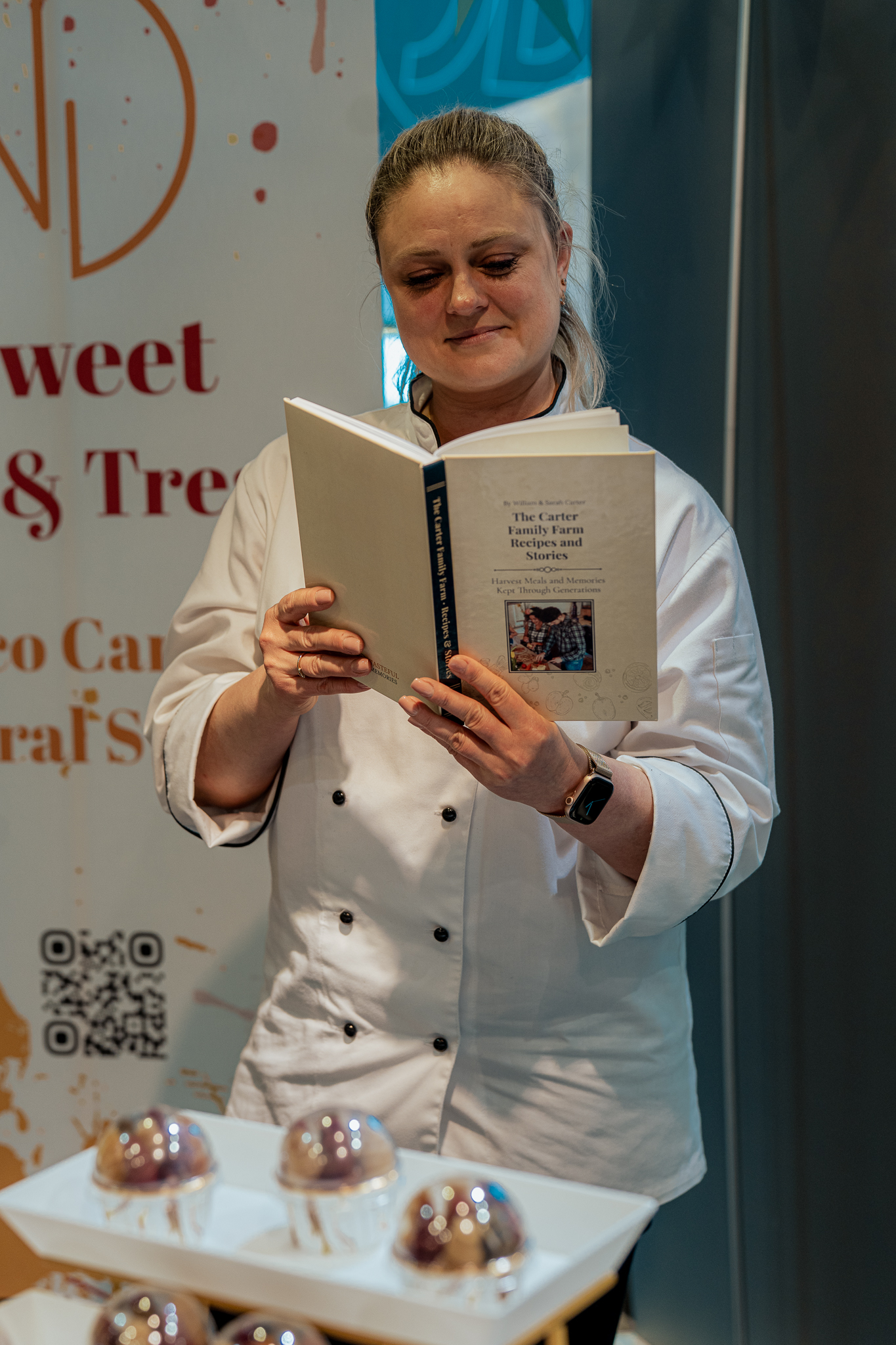 A shelf of personalized Tasteful Memories family cookbooks